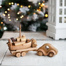 Wonderful set consisting of a beautifully detailed car with a tow trailer. You can use it as it is and add to the trailer whatever toy you want. Add our small boat or our Tug boat as they fit neatly on the back of the transporter.