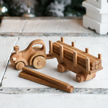 Adorable tractor with wooden log trailer. There is always plenty of work that needs to be done at the farm or the building site. Hitch the trailer to the tractor, load up the logs or animals and move them to a new place. Unhitch the trailer and the Farmer can drive the tractor around the farm or town.