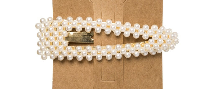 This trending Pearl Hair Clip is the perfect accessory to elevate any outfit!  Made from a metal base, it is delicately detailed with faux pearls.  Designed with a snap closure, these Pearl Hair Clips