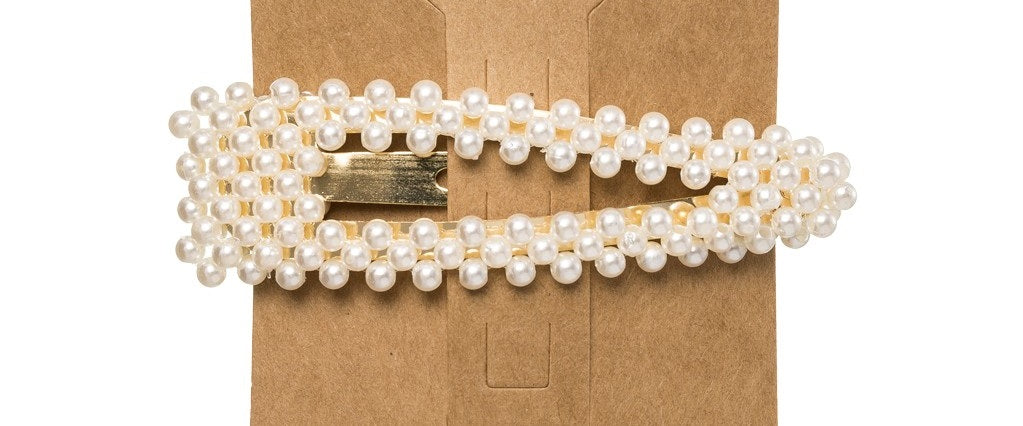 This trending Pearl Hair Clip is the perfect accessory to elevate any outfit! Made from a metal base, it is delicately detailed with faux pearls. Designed with a snap closure, these Pearl Hair Clips