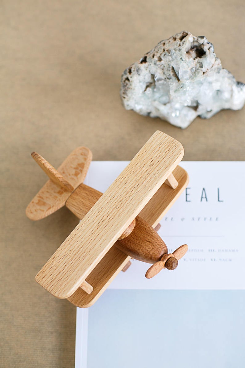 This beautiful wooden airplane is it is made of natural wood (oak and beech). Montessori organic toy.  This original design plane is a perfect birthday gift idea for boys & girls or wooden toys collectors.