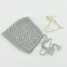 This cosy, textured pixie bonnet is hand knitted in Europe, specially designed for the 21 cm dolls, but can fit dolls around 21 - 30cm ( 8 - 11 inch) Baby Miniland or similar.