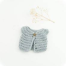 This cosy, textured doll vest is hand knitted in Europe, specially designed for the 38 cm dolls, but can fit dolls around 34 - 40 cm (13 - 15 inch) Miniland, Minikane, Paola Reina Gordis etc, has beautiful details and presents a wooden button at the front to facilitate dressing the doll, just adorable!