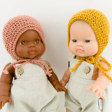 This cosy bonnet is hand knitted in Europe, specially designed for the 34 cm dolls, but can fit dolls around 32 - 38 cm (12 - 15 inch) Miniland, Minikane, Paola Reina Gordis and similar.