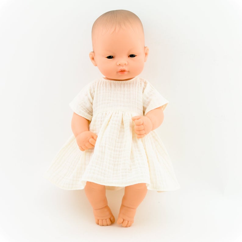 Make your little one's day with this divine doll's ecru muslin dress today. Our dolls clothing is super adorable and of amazing quality, will absolutely melt your heart. Doll dress miniland, minikane, paola reina clothes. Olivia Ann doll clothes