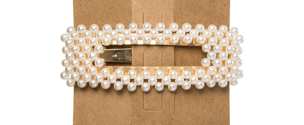 This trending Pearl Hair Clip is the perfect accessory to elevate any outfit! Made from a metal base, it is delicately detailed with faux pearls. Designed with a snap closure, these Pearl Hair Clips