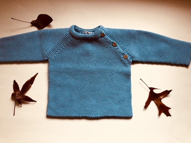 Sweet Unisex knitted Jumper with wooden buttons on the side in an adorable  blue colour. I must have basic piece!