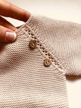 Sweet knitted jumper with wooden buttons in a beautiful beige colour.