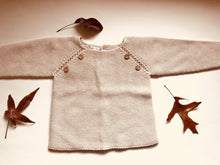 Sweet knitted jumper with wooden buttons in a beautiful beige colour.