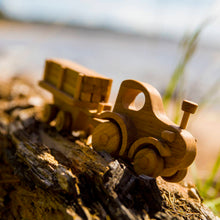 Adorable tractor with wooden log trailer. There is always plenty of work that needs to be done at the farm or the building site. Hitch the trailer to the tractor, load up the logs or animals and move them to a new place. Unhitch the trailer and the Farmer can drive the tractor around the farm or town.