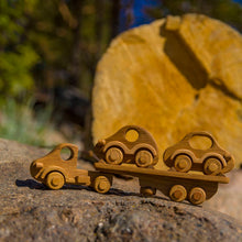 Our beautiful Wooden Car Transporter is a well designed  and of solid construction that will last many years. Sturdy truck with 8 wheels ( with a spare one) and a removable trailer. This wooden transporter has a trailer that transports two beautifully made wooden cars which fit neatly on the back of the transporter.