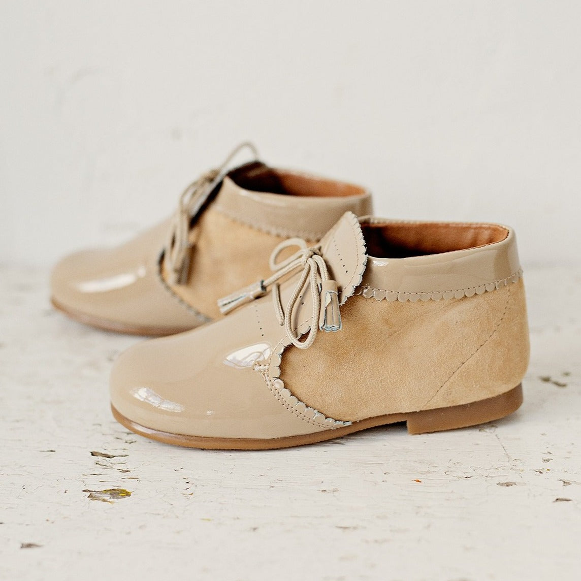 Beautiful smart-casual style lace-up ankle boots with a lovely tassel detail. Made with an adorable combination of Beige Patent Leather and Suede of the highest quality. Olivia Ann Shoes