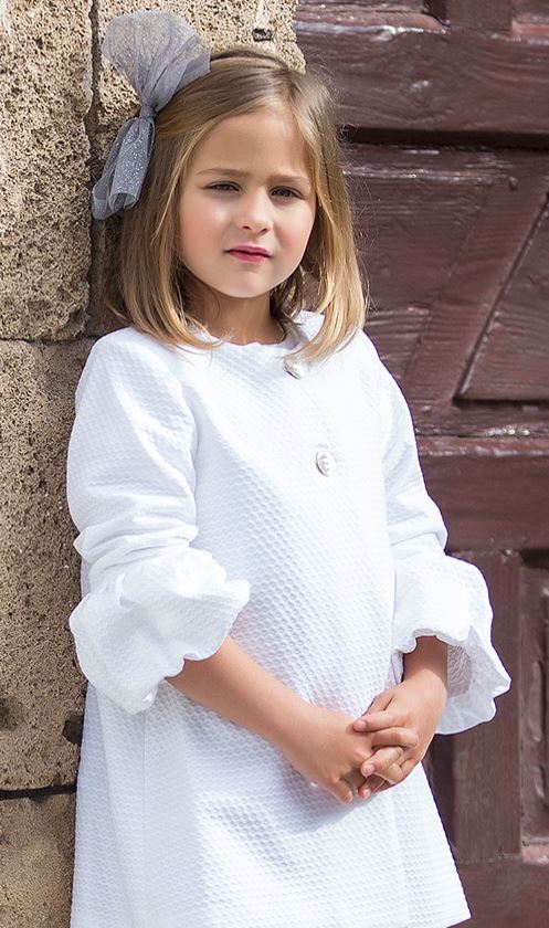 Stunning White Cotton dress. French sleeves puffed from elbow down. Featuring mother-of-the-pearl buttons at the front. Fully lined. A really special piece! 