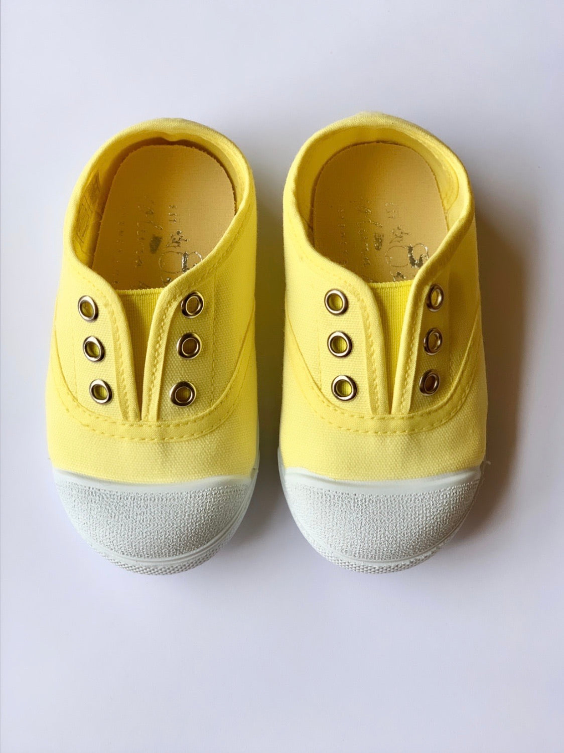 Our OLIVIA ANN soft canvas shoes have a new and improved material that is supersoft and comfortable, and perfect for speedy slip-ons when there's a game in the garden. Plimsoles, sneakers. Kids shoes. Lemon.