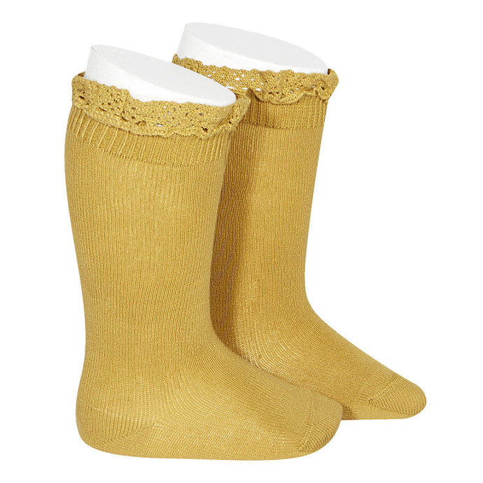 A very special  pair of socks, featuring an beautiful lace edging cuff in a delicate mustard colour.  Very good quality socks. Super soft. It will add a beautiful touch to any outfit!  Condor socks mustard