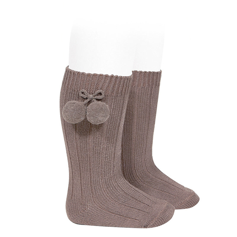 Beautiful and elegant Knee High Ribbed socks with Pom-Poms. An stunning addition to your little one's outfit! Fun and elegant.  praline condor
