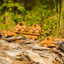 Our beautiful Wooden Car Transporter is a well designed  and of solid construction that will last many years. Sturdy truck with 8 wheels ( with a spare one) and a removable trailer. This wooden transporter has a trailer that transports two beautifully made wooden cars which fit neatly on the back of the transporter.